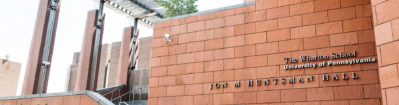 MBA_Visiting_Hero_1900x500-1-1900x500 Facade of Jon M. Huntsman Hall at The Wharton School, University of Pennsylvania, featuring modern architectural elements with reddish-brown tiles.
