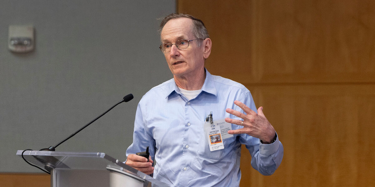 Albert "Pete" Kyle in discussion at the IMF-WIFPR Conference.